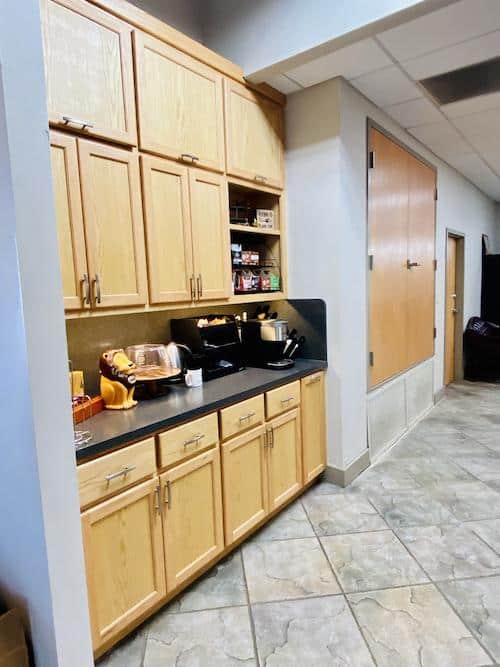 brown cabinets and black counter with snacks