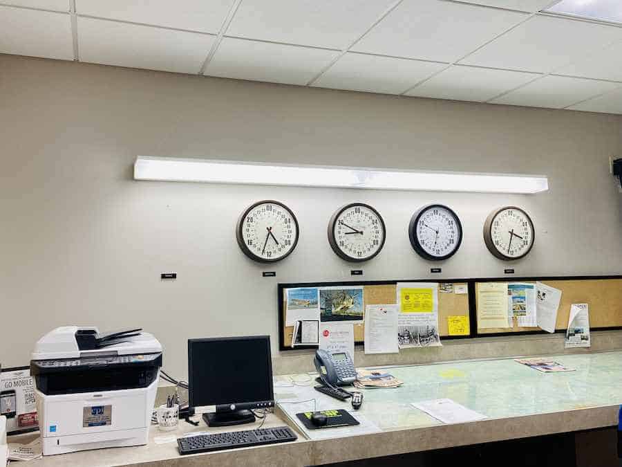 Flight planning room with four clocks., printer and supplies